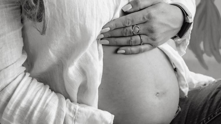 Pregnant woman holding her belly — pregnancy, PCOS and women's health checks